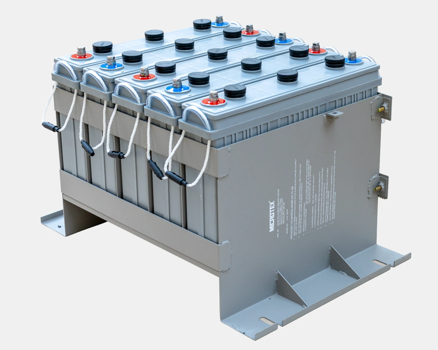 Microtex 6V 120Ah VRLA train lighting battery monoblocs in a steel under-slung coach tray · caption FIG. 2 — 6V 120Ah VRLA MONOBLOCS IN COACH TRAY